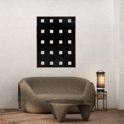 Modern Japandi interior with a wicker sofa, glass coffee table, and an abstract wall art of ivory squares neatly aligned on a soft black background.