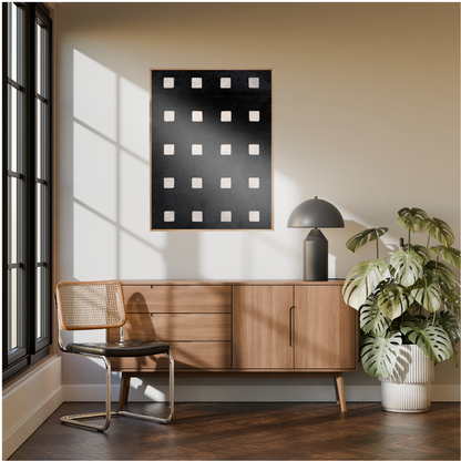 Modern interior with a Wabi Sabi geometric artwork of ivory squares framed above a wooden cabinet, chair, and a decorative plant.