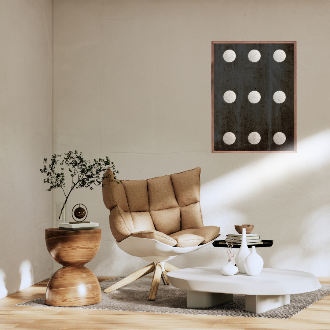 Modern living room with a beige armchair, wooden side table, and abstract Wabi Sabi wall art with neutral circles on a dark background.