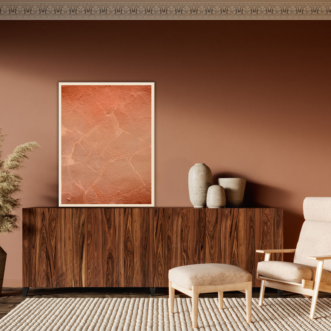 Modern interior with wooden console table, chair, minimalist vases and a terracotta abstract art on a rustic toned wall.