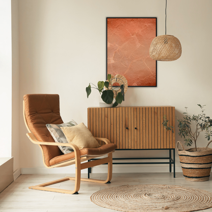 Cozy reading area with brown armchair, wooden cabinet, and decorative elements featuring an abstract art piece in terracotta tones.